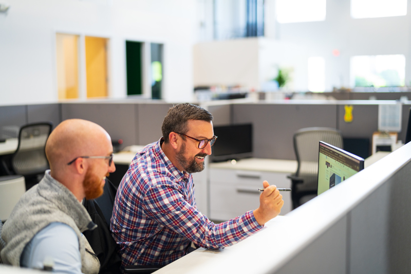 two men working together on a project design